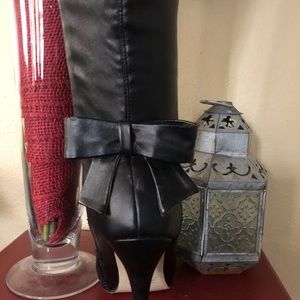 Beautiful pair of knee high black boots with bow